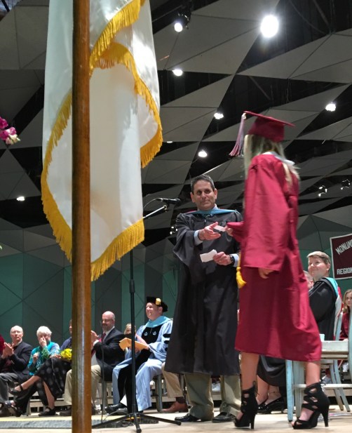 Graduate crosses the stage