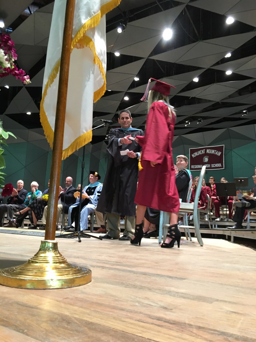 Graduate walking across the stage