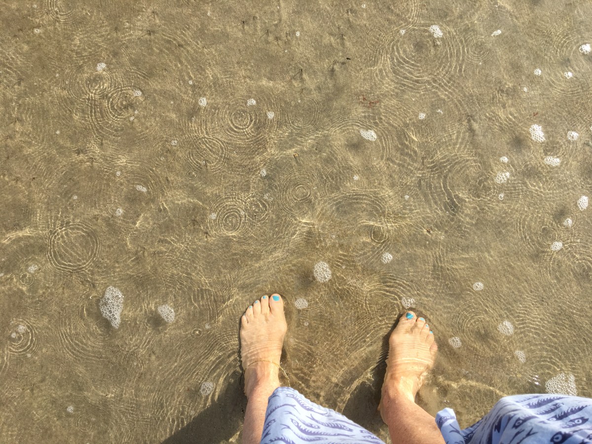 feet in the sand on Santa Monica beach