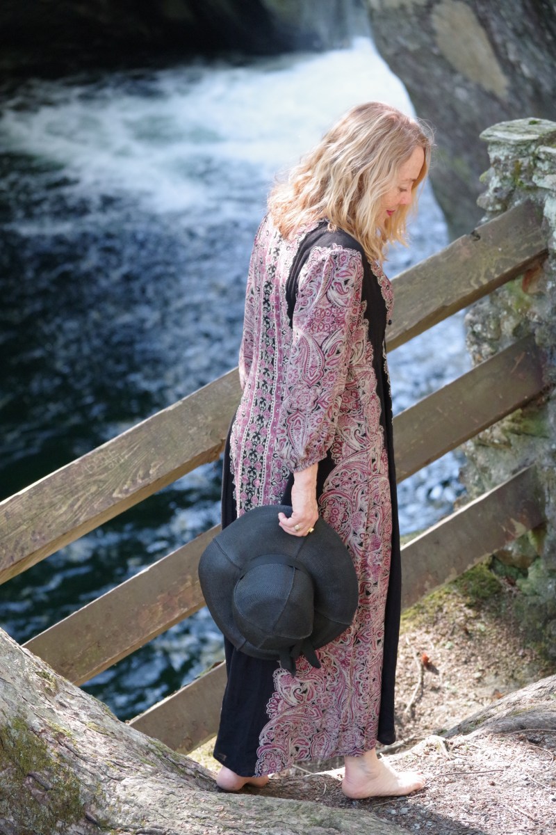 standing by the waterfall