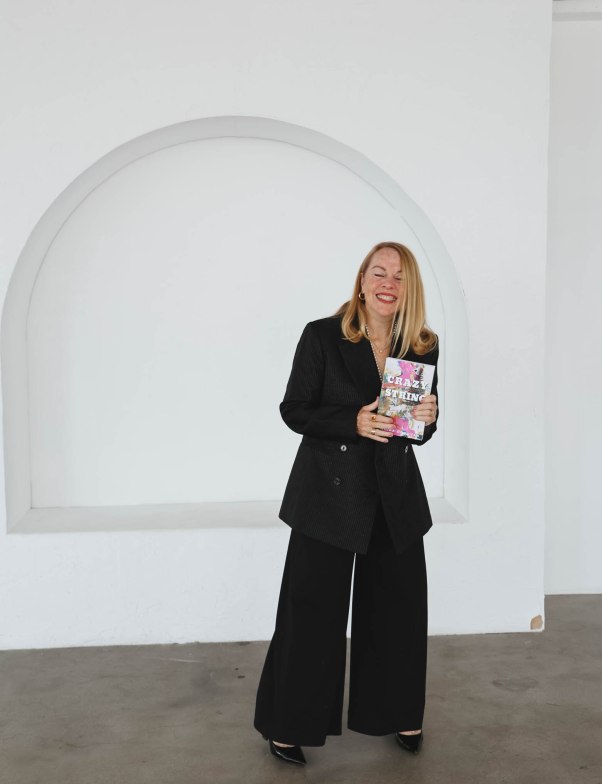 Author holding her novel, Crazy String